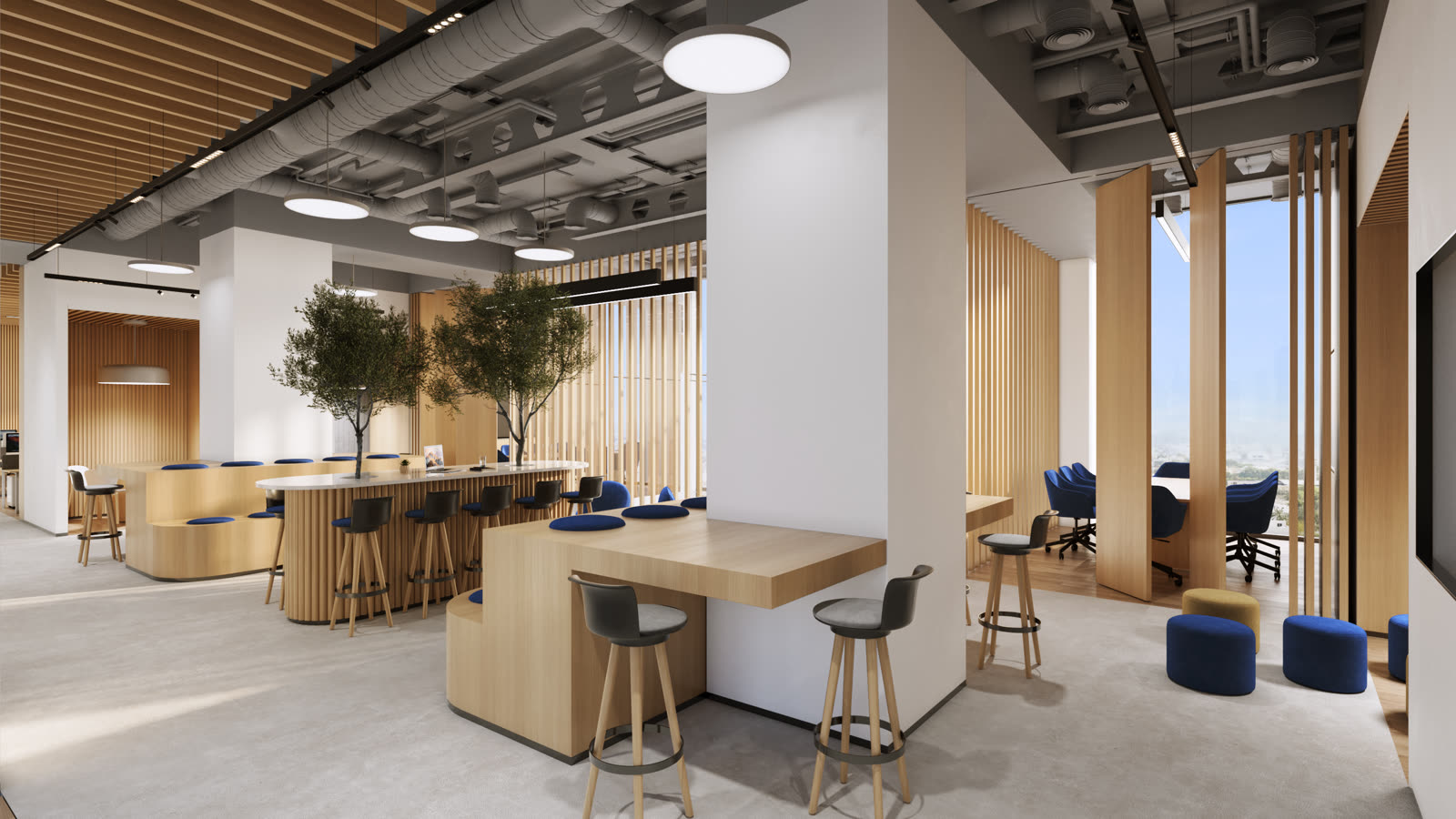 Townhall area with a timber bar, stools and olive trees under exposed ceilings