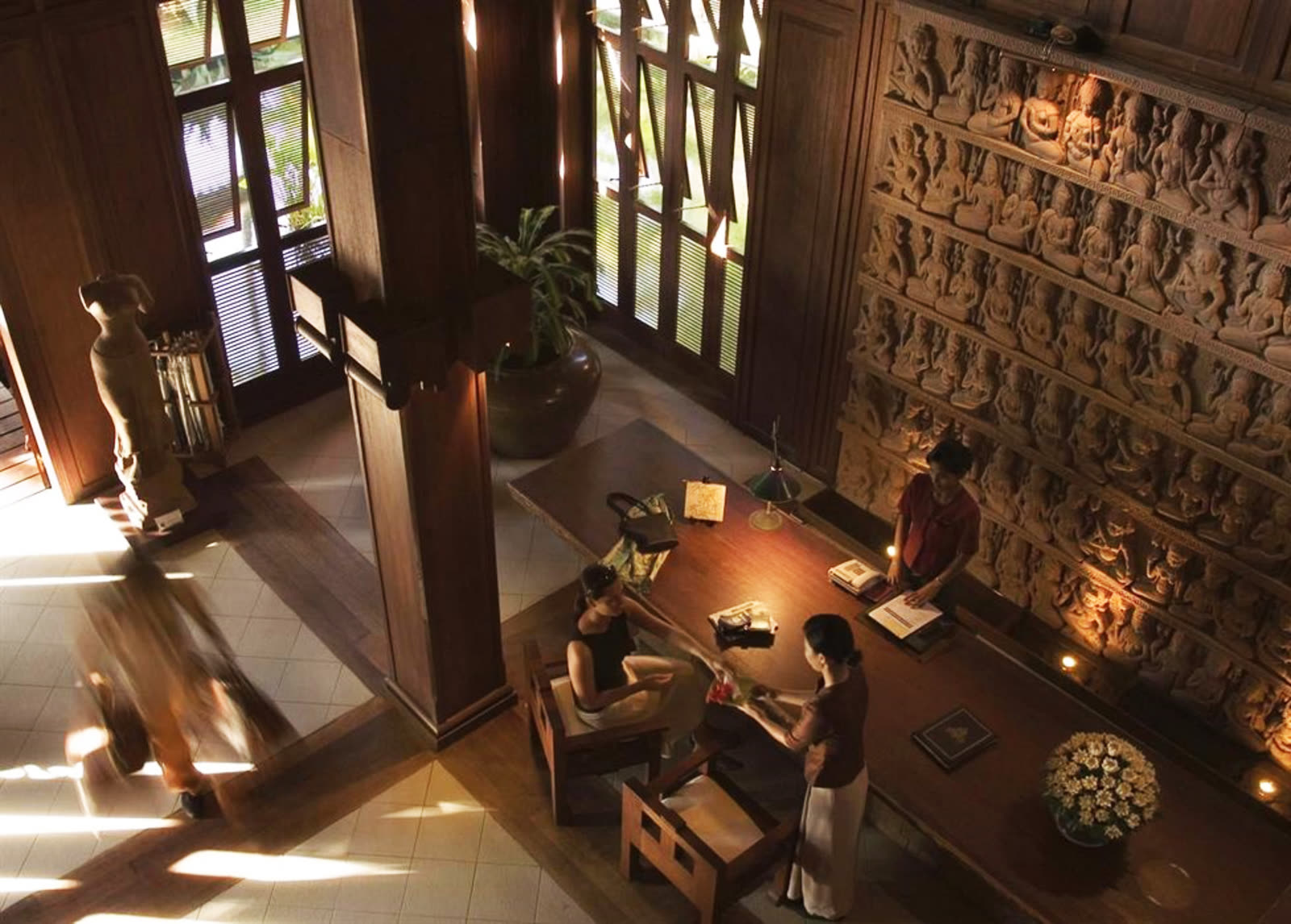 Carved stone wall and warm lighting seen from above in the lobby