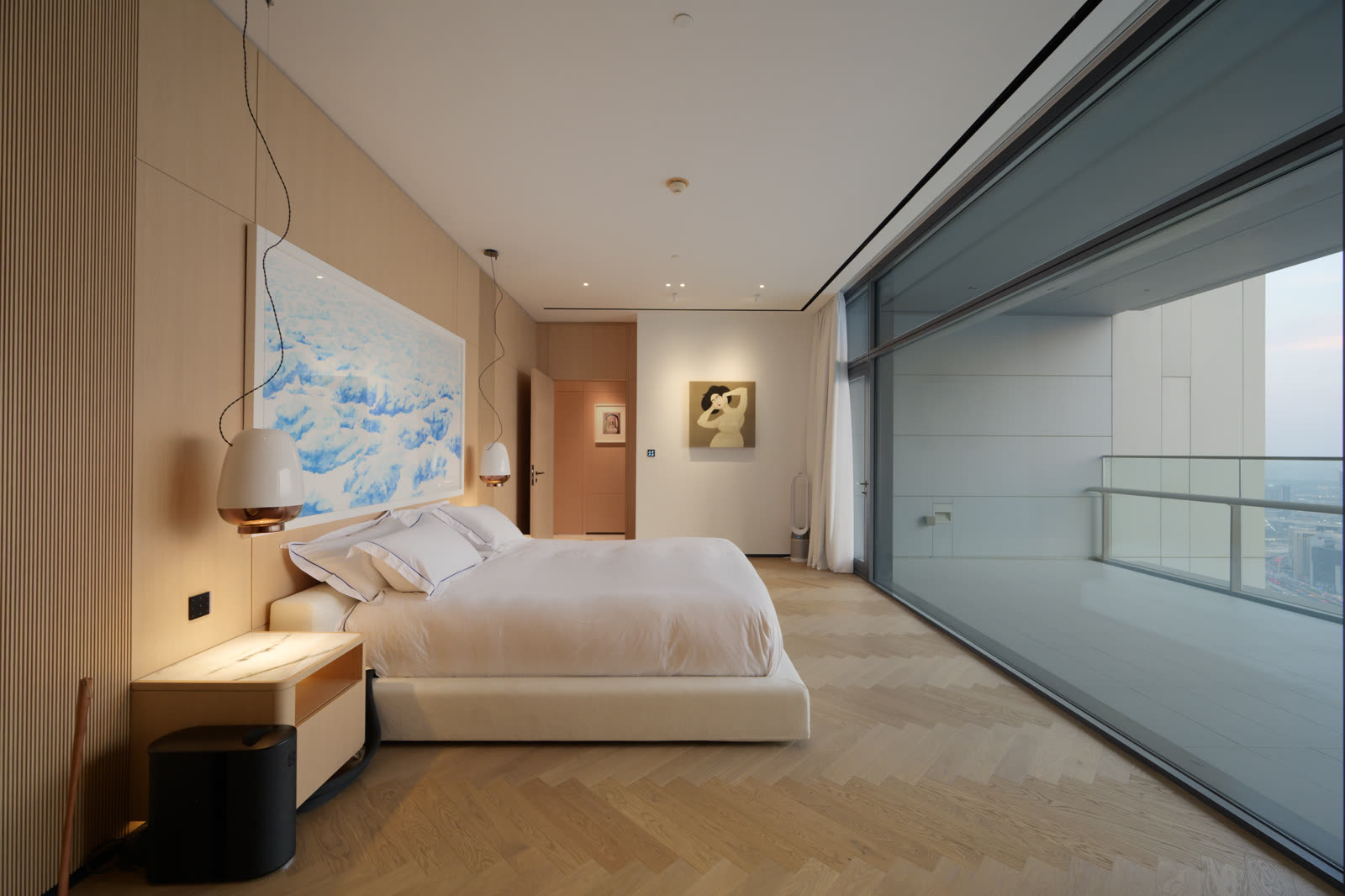 Bedroom with a low bed, timber panelling and a floor-to-ceiling window over the city